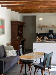a living room with a table and a couch at La Finca in Nîmes