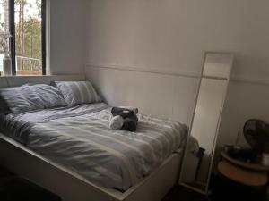 a bed with a teddy bear on it in a bedroom at Tamesis - Wildernest in Neranie +6 photos