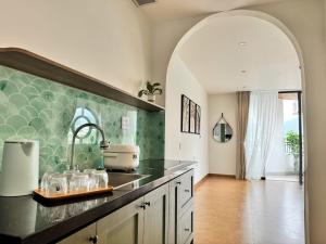 a kitchen with a sink and a counter top at An House Son Tra in Danang +30 photos