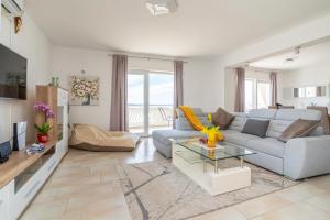 a living room with a couch and a table at Apartman D&D in Starigrad