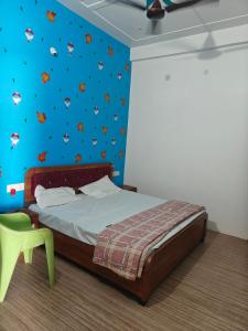 a bedroom with a bed and a wall with fish on it at Shri Ram Vila Guest House in Ayodhya