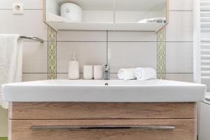 a bathroom with a white sink and a mirror at Apartman D&D in Starigrad +60 photos