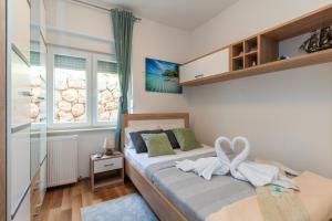 a bedroom with a bed with a bow on it at Apartman D&D in Starigrad