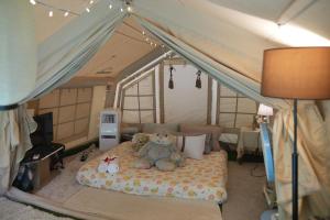 two teddy bears sitting on a bed in a tent at Le Rafting & Le Camping in Ban Hin Dan