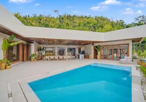 a swimming pool in the backyard of a house at Villa Seresa Premium- La Union in Bacnotan