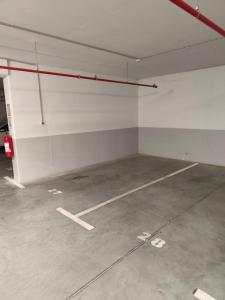 an empty parking lot in an empty parking garage at Komitet Planet Apartment - Free Garage & Modern stay in Niš