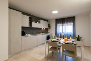 a kitchen and dining room with a table and chairs at Suite1212 - Rattazzi in Monopoli