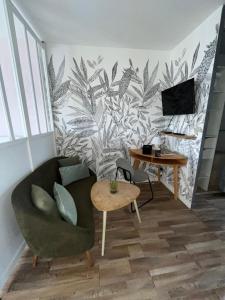 a living room with a couch and a table at Studio St Marc - plage à 300m in Saint-Nazaire