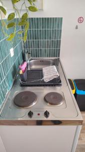 a stove top with a sink in a kitchen at Studio St Marc - plage à 300m in Saint-Nazaire