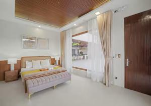 a bedroom with a bed and a large window at Villa Seresa Premium- La Union in Bacnotan +9 photos