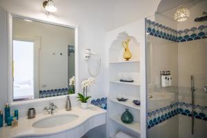 a bathroom with a sink and a shower at Villa Santa Chiara Positano Suites in Positano +186 photos