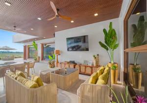 a living room filled with furniture and a ceiling fan at Villa Seresa Premium- La Union in Bacnotan