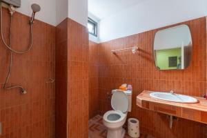 a bathroom with a toilet and a sink and a mirror at Best Beach Bungalows in Chaweng +17 photos