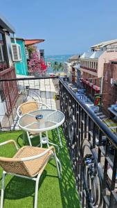 a table and chairs sitting on top of a balcony at Destination Boutique Hotel in Pattaya +21 photos