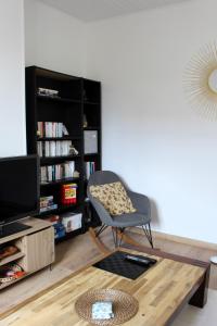a living room with a chair and a table at L'écoutille in Dieppe