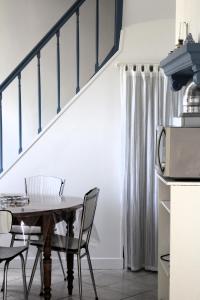 a dining room with a table and chairs at L'écoutille in Dieppe