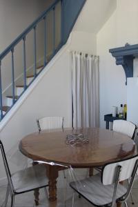 a dining room with a wooden table and chairs at L'écoutille in Dieppe +17 photos