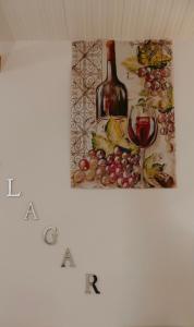 a painting of a bottle and a glass of wine at Cosy Tiny House Centro Vila Real in Vila Real