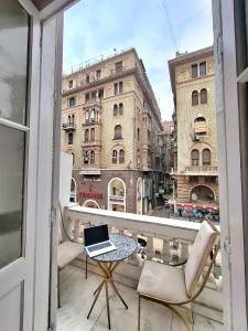 a balcony with a laptop on a table and a city at Hotel velvet One in Cairo
