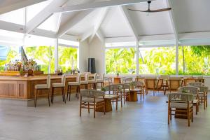 a restaurant with tables and chairs and a bar at Carlisle Bay in Old Road