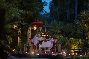 a group of three people standing around a table at Tonys Villas & Resort Seminyak - Bali in Seminyak +62 photos