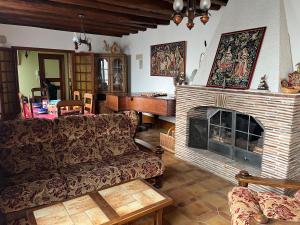 a living room with a couch and a fireplace at Les Billardières - Suite familiale de 2 chambres entre Blois et Chambord, proche Loire à Vélo in Cour-sur-Loire