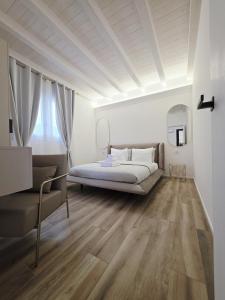 a bedroom with a bed and a couch at The K Noir Private Pool Luxury Suite in Civé