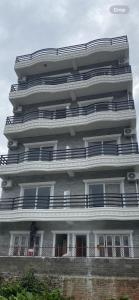 a tall white building with balconies on the side of it at The Staycation Pokhara in Pokhara