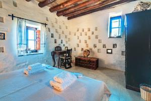 a room with a bed and a table in it at The Vintage Dovecote in Mesariá
