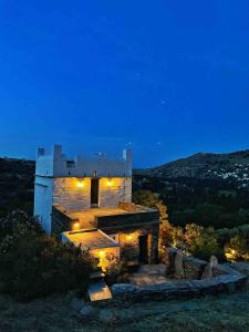 a stone building with lights on it at night at The Vintage Dovecote in Mesariá