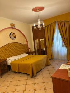a bedroom with a large bed and a chandelier at Bed & Breakfast Casa Anna Rita in Vietri sul Mare +121 photos