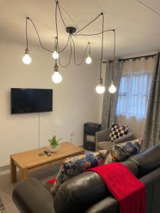 a living room with a couch and a table at Townside Estate UNIT8 in Ladysmith +6 photos