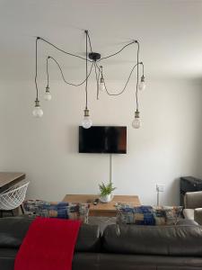 a living room with a black couch and lights at Townside Estate UNIT8 in Ladysmith