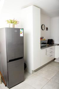 a kitchen with a stainless steel refrigerator next to a counter at Townside Estate UNIT8 in Ladysmith