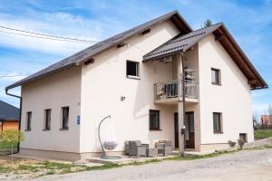 a white house with a black roof at Apartman Vanessa in Gospić
