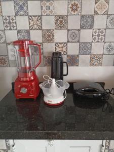 a red blender sitting on top of a counter at Casa Carlotta in Paracuru