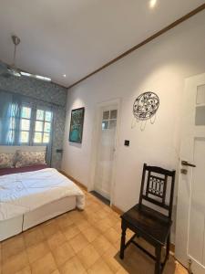 a bedroom with a bed and a chair at The Amar Vilas in Dehradun