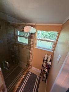 a small bathroom with a shower and a window at Backyard Cottage in Naples