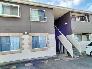 a house with a staircase in front of it at Sakura Inn in Chiba