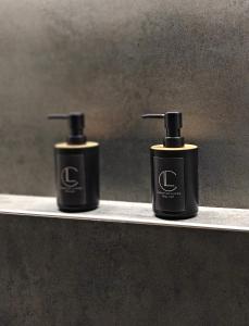 two bottles ofodorizers sitting on a shelf at Celestial Luxury SKG Port in Thessaloniki +14 photos