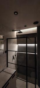 a bathroom with a shower with a glass door at Celestial Luxury SKG Port in Thessaloniki