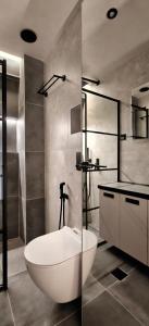 a bathroom with a white bath tub and a sink at Celestial Luxury SKG Port in Thessaloniki