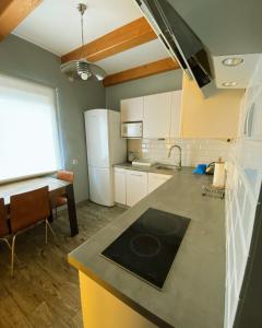 a kitchen with a counter and a kitchen with a sink at Domek Eve in Giżycko