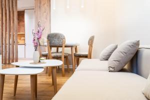 a living room with two beds and a table at Modern Apartment with Balcony & Fast Wi-Fi & Self Check-in in Shkodër
