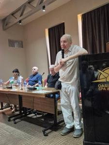 a man standing in front of a microphone at Hotel in Tbilisi City