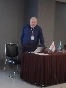 a man standing behind a table with a laptop at Hotel in Tbilisi City
