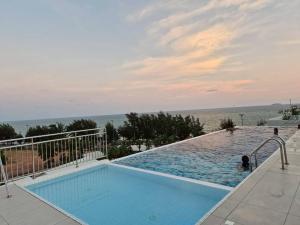 a swimming pool with a view of the ocean at Mosaic condominium RoomBD64M in Klaeng