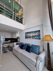 a living room with a couch and a table at Mosaic condominium RoomBD64M in Klaeng