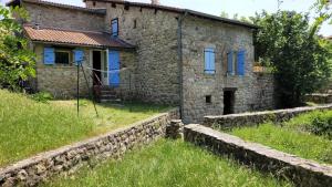 a stone house with blue doors and a stone wall at Maison en pierre Ardèche du sud in Valgorge +8 photos