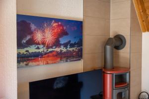 a painting of a fireworks display on a wall at Ferienhaus Klapötke in Dorum +39 photos